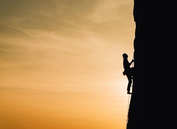 person climbing a rock