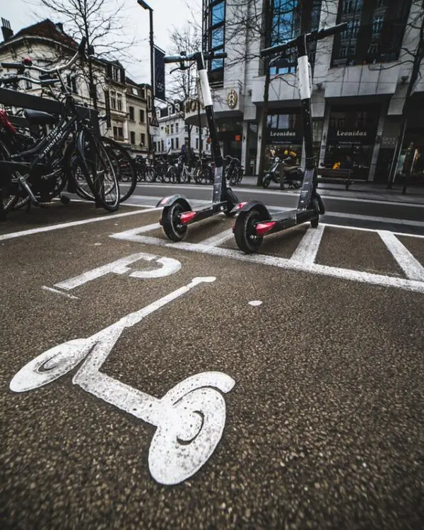 two rental electric scooters used for last mile transportation in a big city