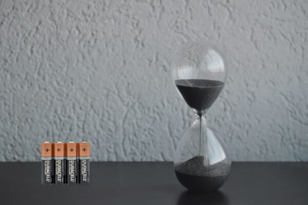 batteries next to an hourglass showing a lot of time has passed