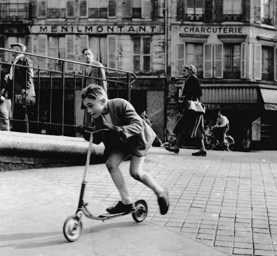 kid riding a scooter manually