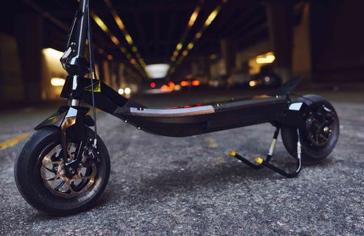 bottom side view of a black Rion electric scooter on its stand in a tunnel
