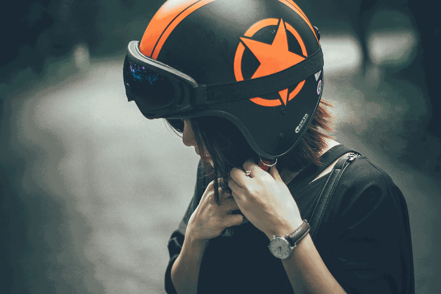 person putting on a helmet for riding an electric scooter