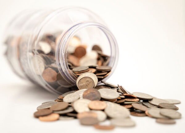 many coins spilling over from a jar