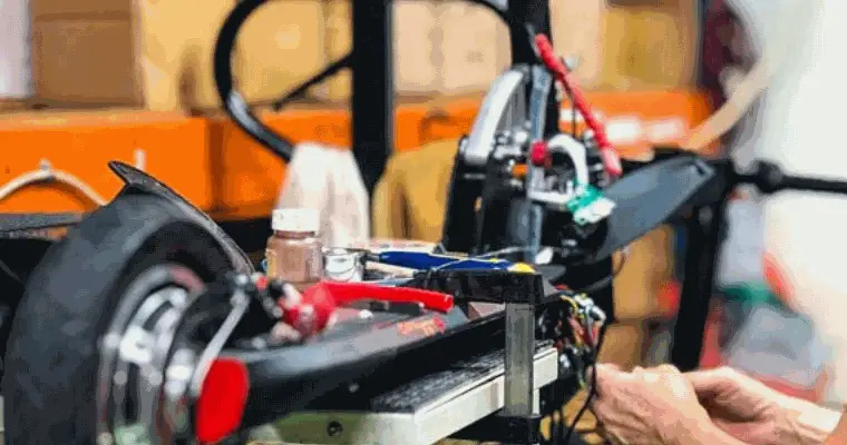 person repairing an electric scooter