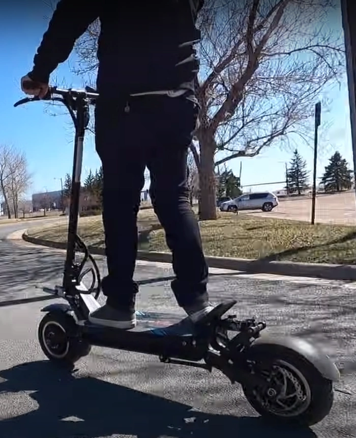 A closeup of a guy riding the Bronco Xtreme scooter