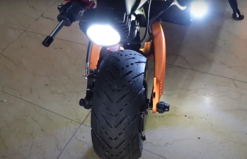 A closeup of the front tire and light of the Blade 10 GT+ e-scooter