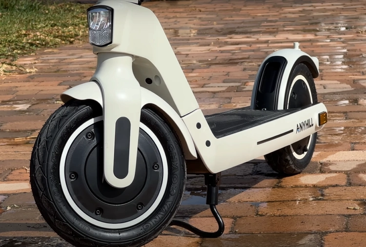 A closeup of the kickstand, tires, deck, and front light of the Anyhill UM-2