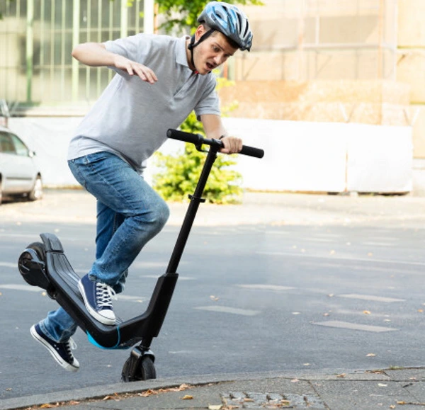 A man falling off an electric scooter