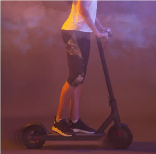 A woman riding an electric scooter