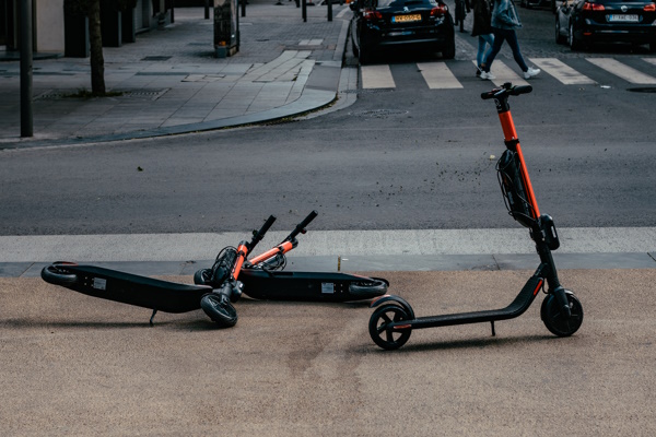 E-scooters lying on a sidewalk