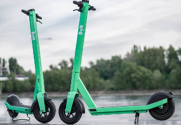 two green Bolt rental electric scooters