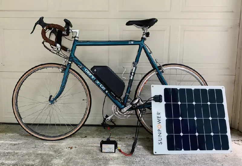 electric bike being charged by a solar panel