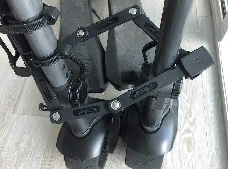 foldable lock for electric scooters around two black electric scooters