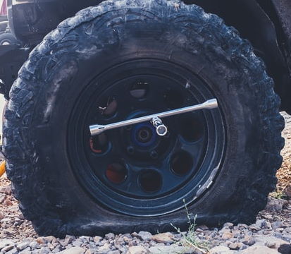 flat tire with a tire repair tool in the valve