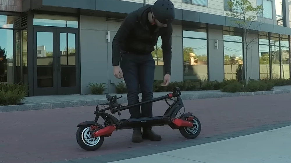 guy folding a turbowheel scooter