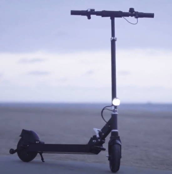 side view of the Glion Dolly scooter standing on sand