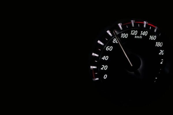 speedometer in the dark with white numbers showing around 90 km/h