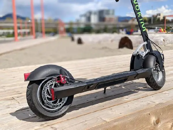 low view of the Inokim Quick 3 Super electric scooter standing on a wooden deck