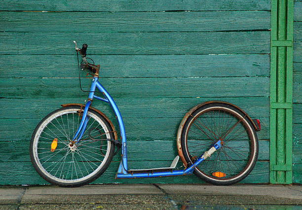 a blue kickbike - a vehicle that looks like a mix of a bike and a scooter