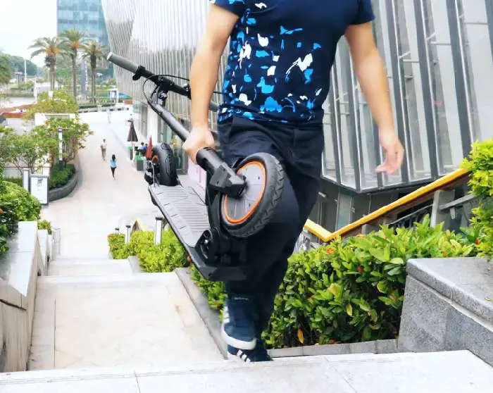 person carrying the Kugoo M2 Pro