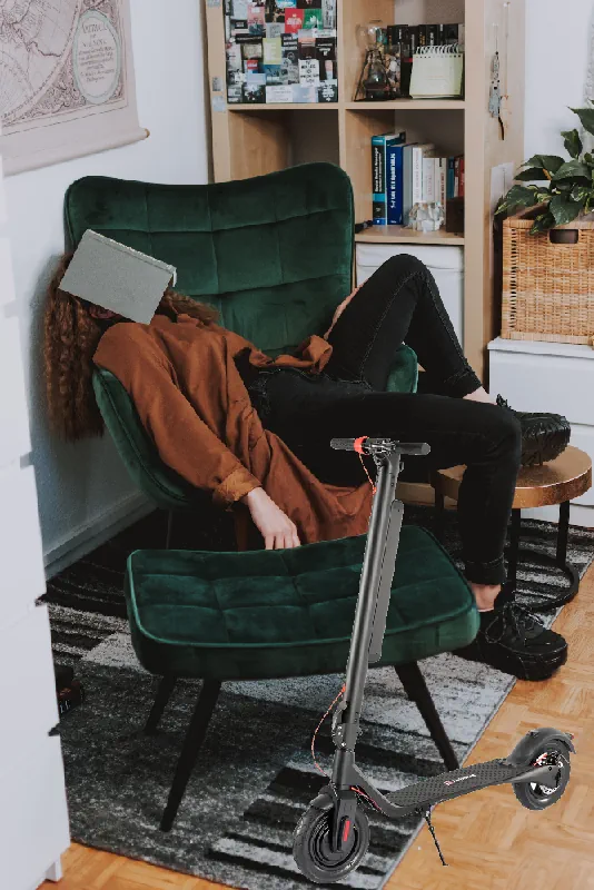 lazy person sleeping on a couch with an electric scooter in the living room