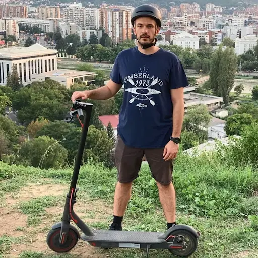 Matt from EScooterNerds standing next to his Xiaomi M365 Pro