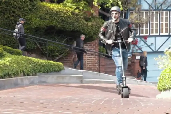 person climbing a hill on a Mercane WideWheel Pro