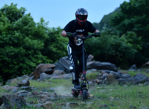 A man riding an e-scooter on a mountain