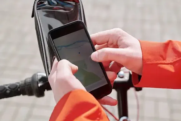 person connecting their electric scooter controller to a smartphone app