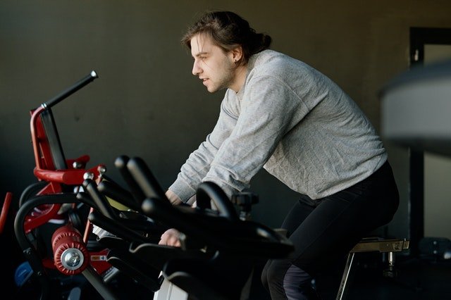 person exercising on a bicycle in a gym