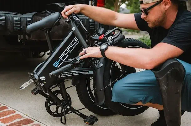 person inspecting electric bike