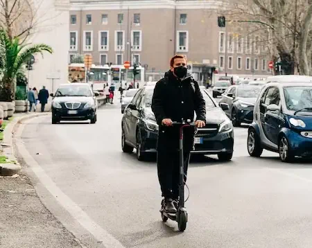 person navigating busy streets on an electric scooter