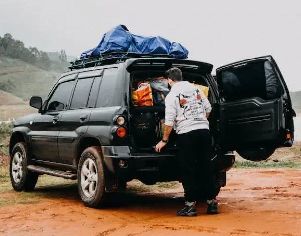 person preparing their car for a long travel