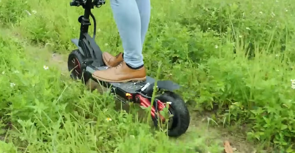 a guy riding Kugoo G-Booster on rough terrain