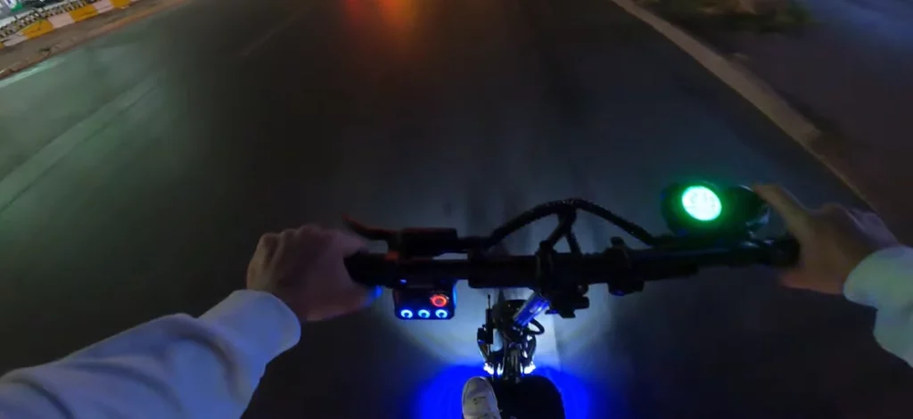 electric scooter with lights on during nighttime ride.