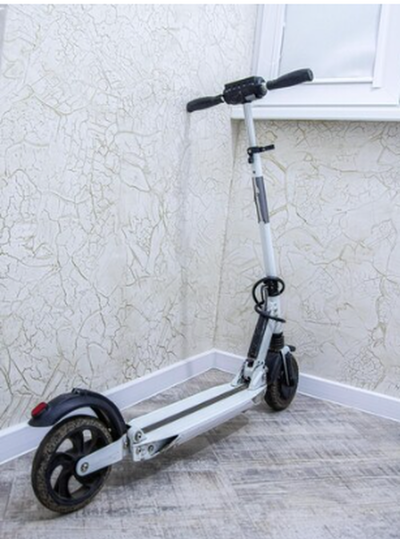 An electric scooter being kept in a room