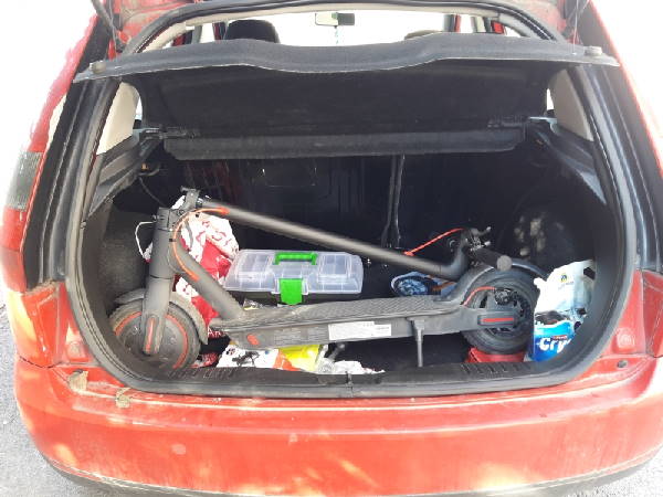 folded Xiaomi M365 Pro electric scooter fitting into the trunk of a Ford Focus car