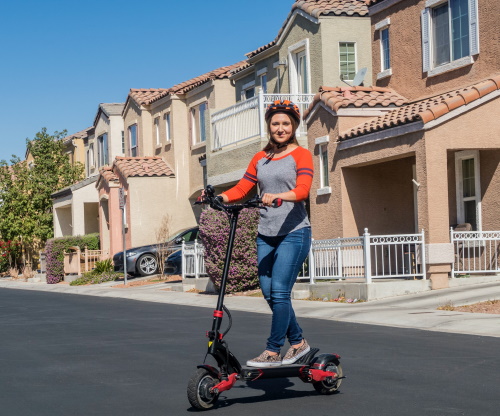 A girl standing upright on an e-scooter