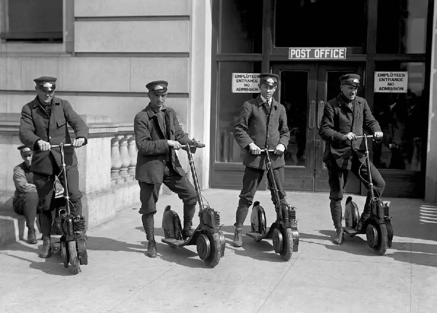 US postmen with their motorized scooters