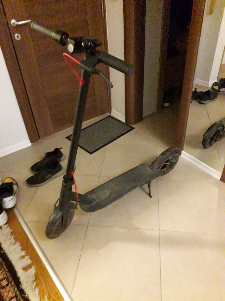 Xiaomi M365 Pro standing on a stand in a living room